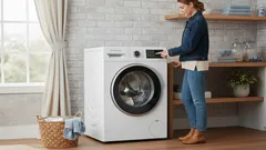 Vrouw bedient moderne wasmachine in lichte wasruimte met wasmand op de vloer.