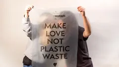 twee mensen houden bord vast met tekst maak liefde, geen plastic afval